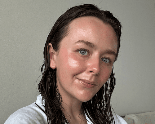 close up of woman with smooth face skin on gray background