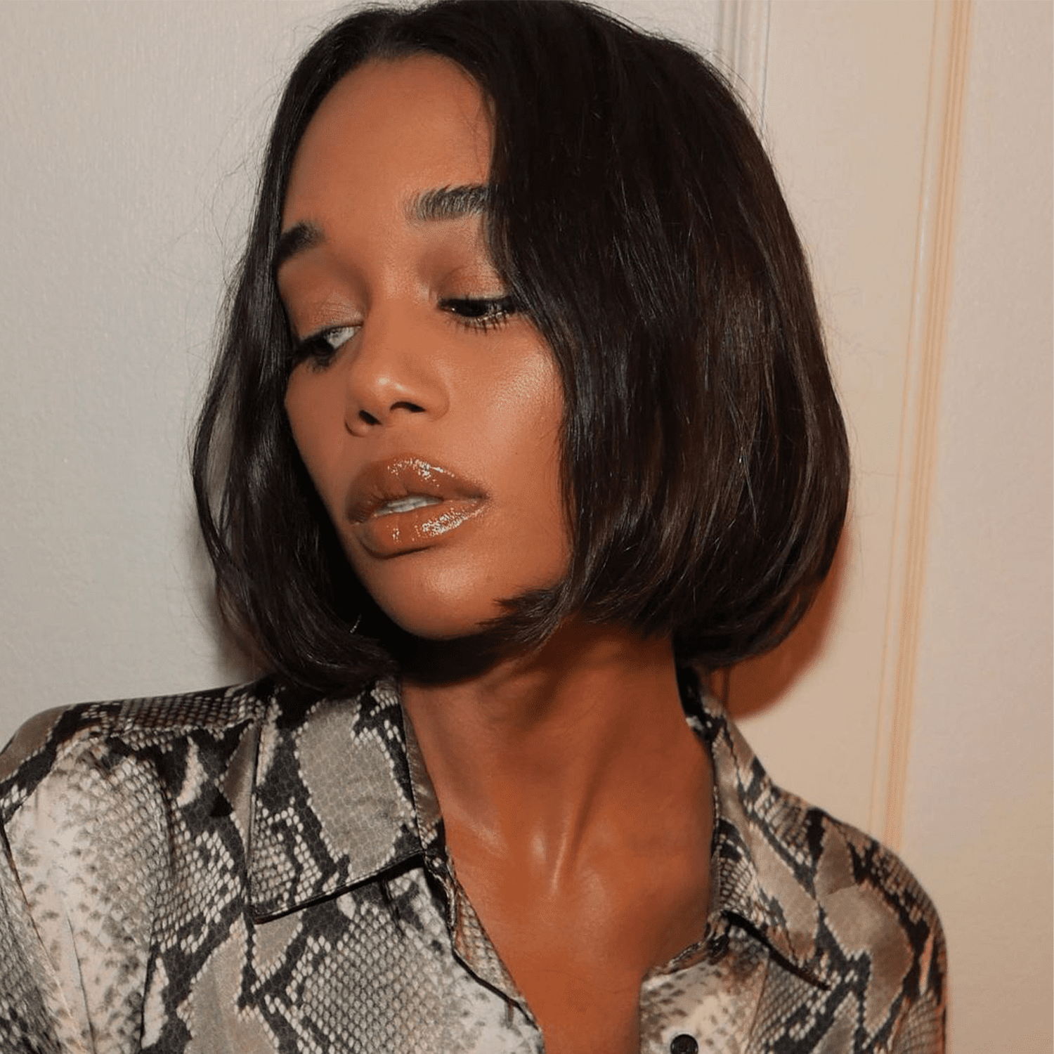 Laura Harrier wearing the strategic shine makeup trend