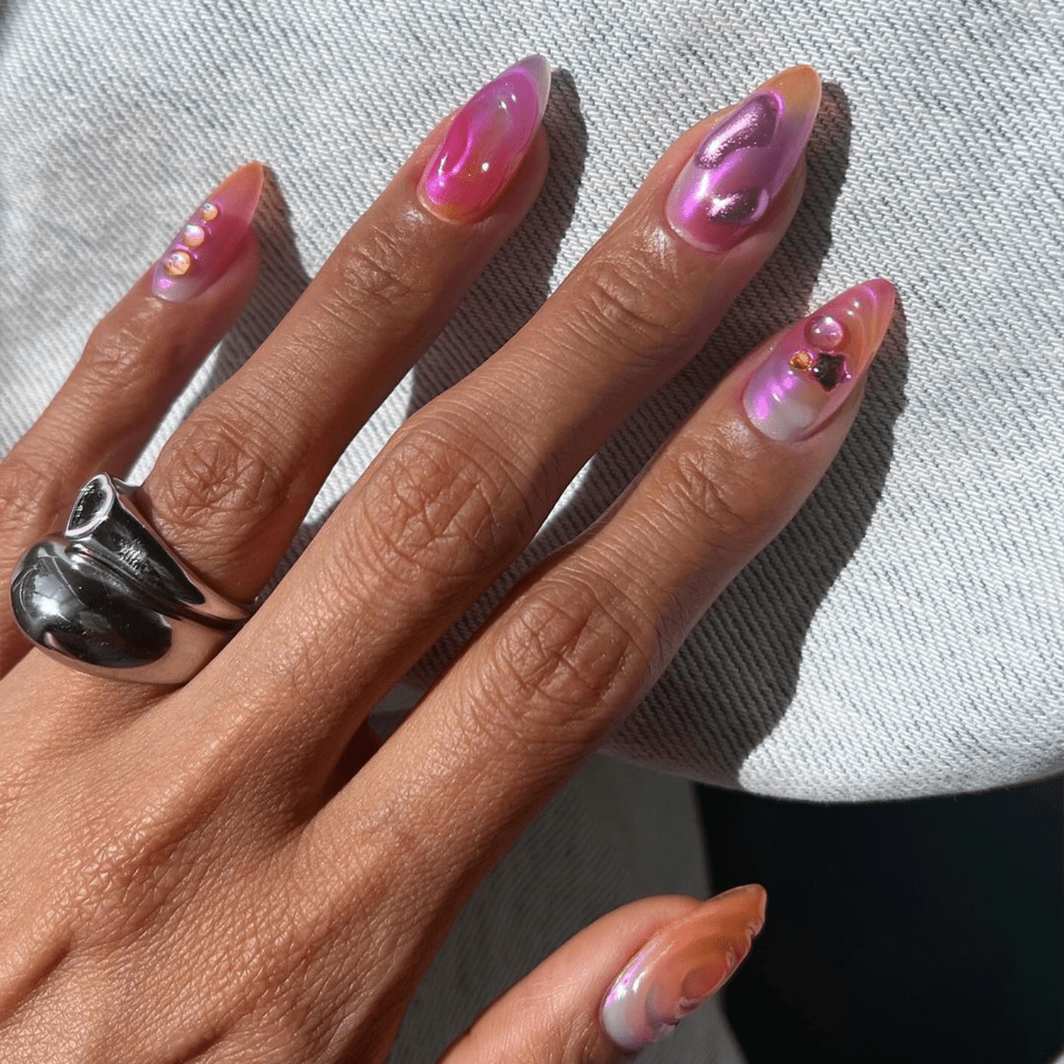 pink and purple chrome nails with 3d designs