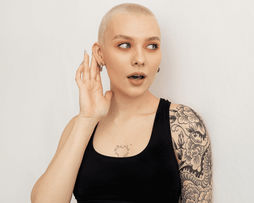 woman with blonde buzzcut and tattoos