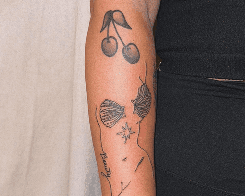 close up of woman's arm with sticker sleeve tattoos