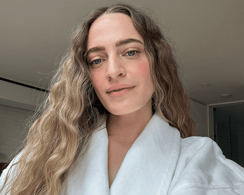 woman's selfie in robe showing messy beach waves