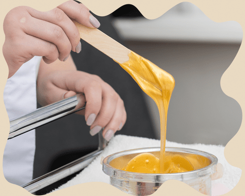 Woman holding up stick of hair-removal wax